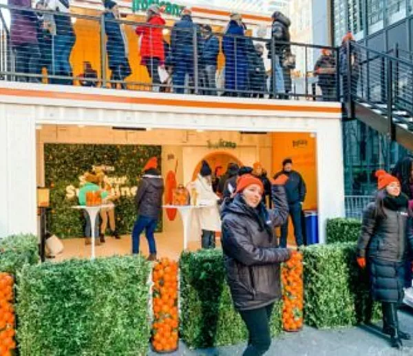 People posing in front of the Tropicana BoxPop activation